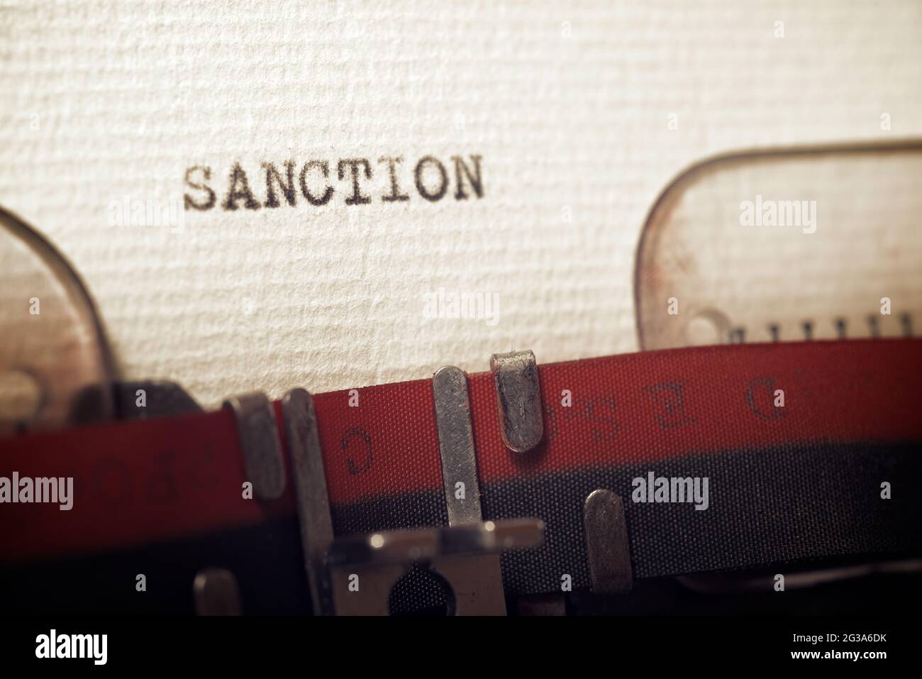 The word sanction written with a typewriter. Stock Photo