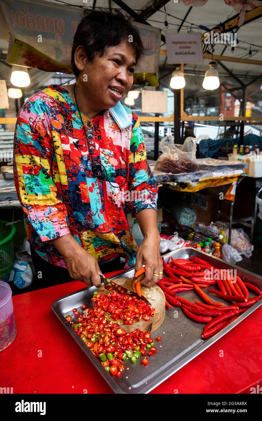 A Thai street food vendor slices a plentiful amount of red, yellow and  green peppers to use as an ingredient in her takeaway food business Stock  Photo - Alamy