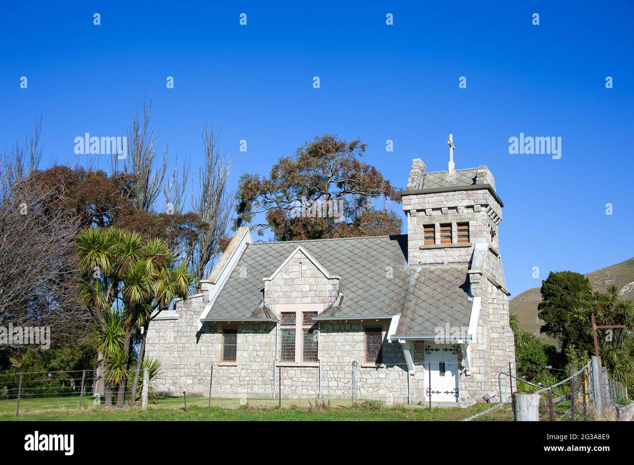 St. Oswald's Memorial Church, Wharanui, Kaikoura Coast, Malborough, New Zealand. Pretty little stone church in a green rural landscape Stock Photo