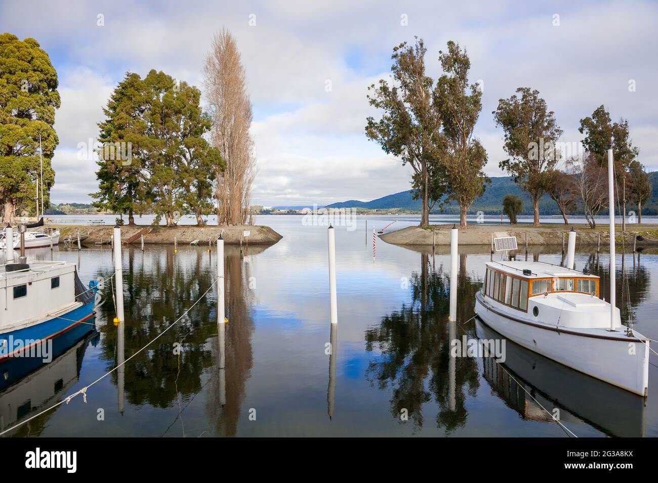 Te Anau Marina, Fiordland, New Zealand. Tranquil scene, leisure boats moored on a lake with reflections in calm water Stock Photo
