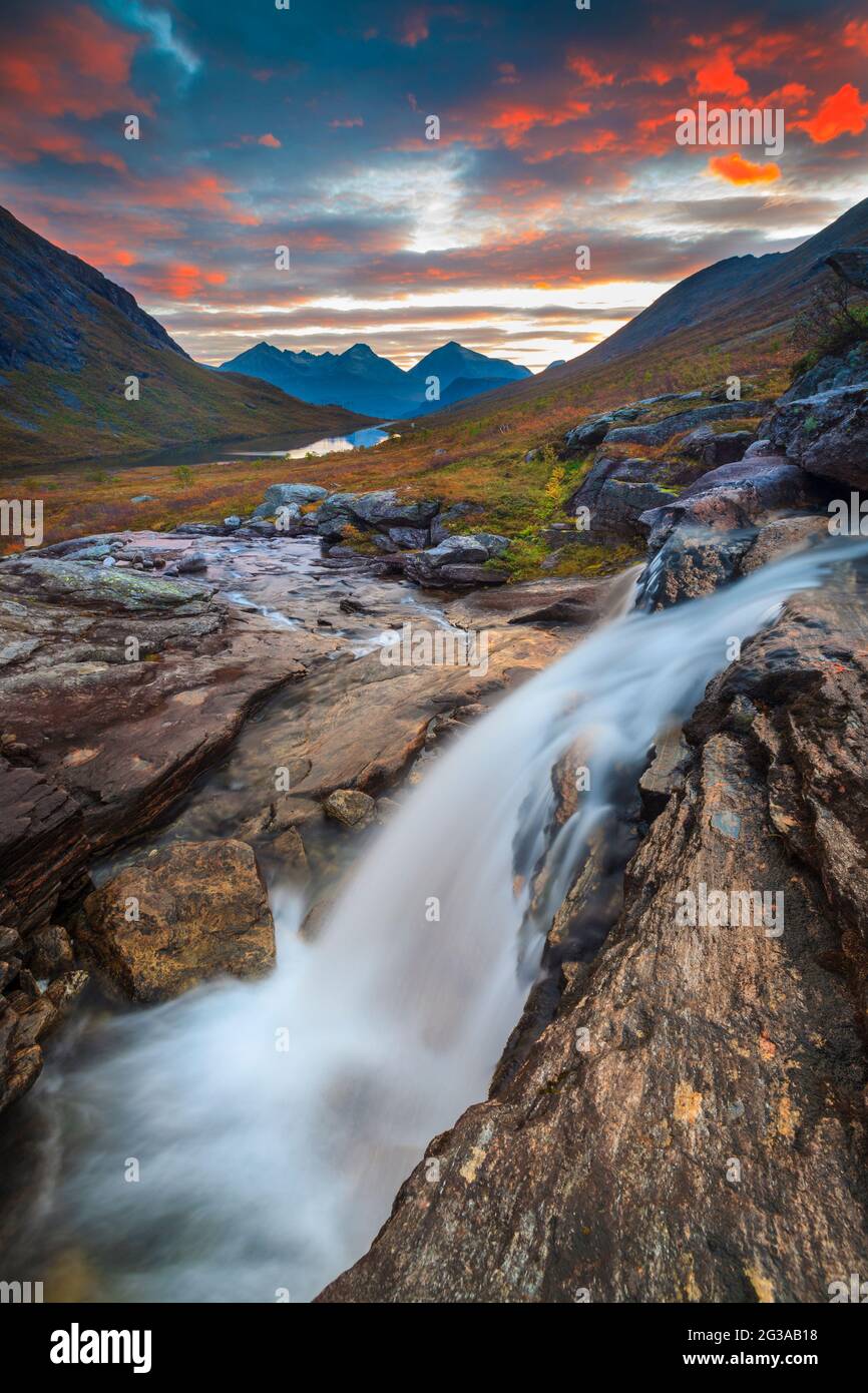 Striking landscape in Vengedalen with waterfall, mountains, and early morning colorful sky, Rauma kommune, Møre og Romsdal, Norway, Scandinavia. Stock Photo