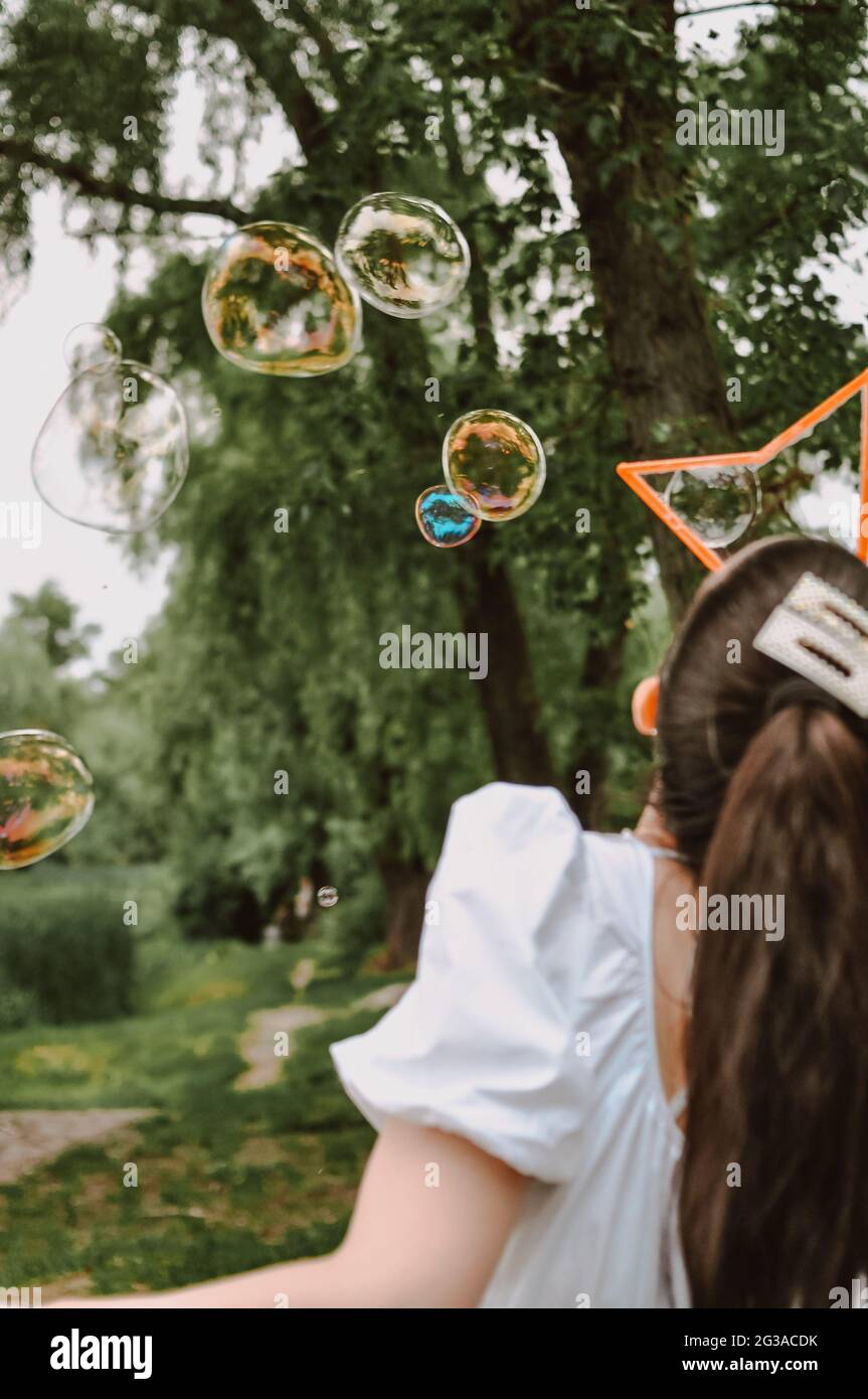 Big soap bubbles in the forest in summer copy space, background  Stock Photo