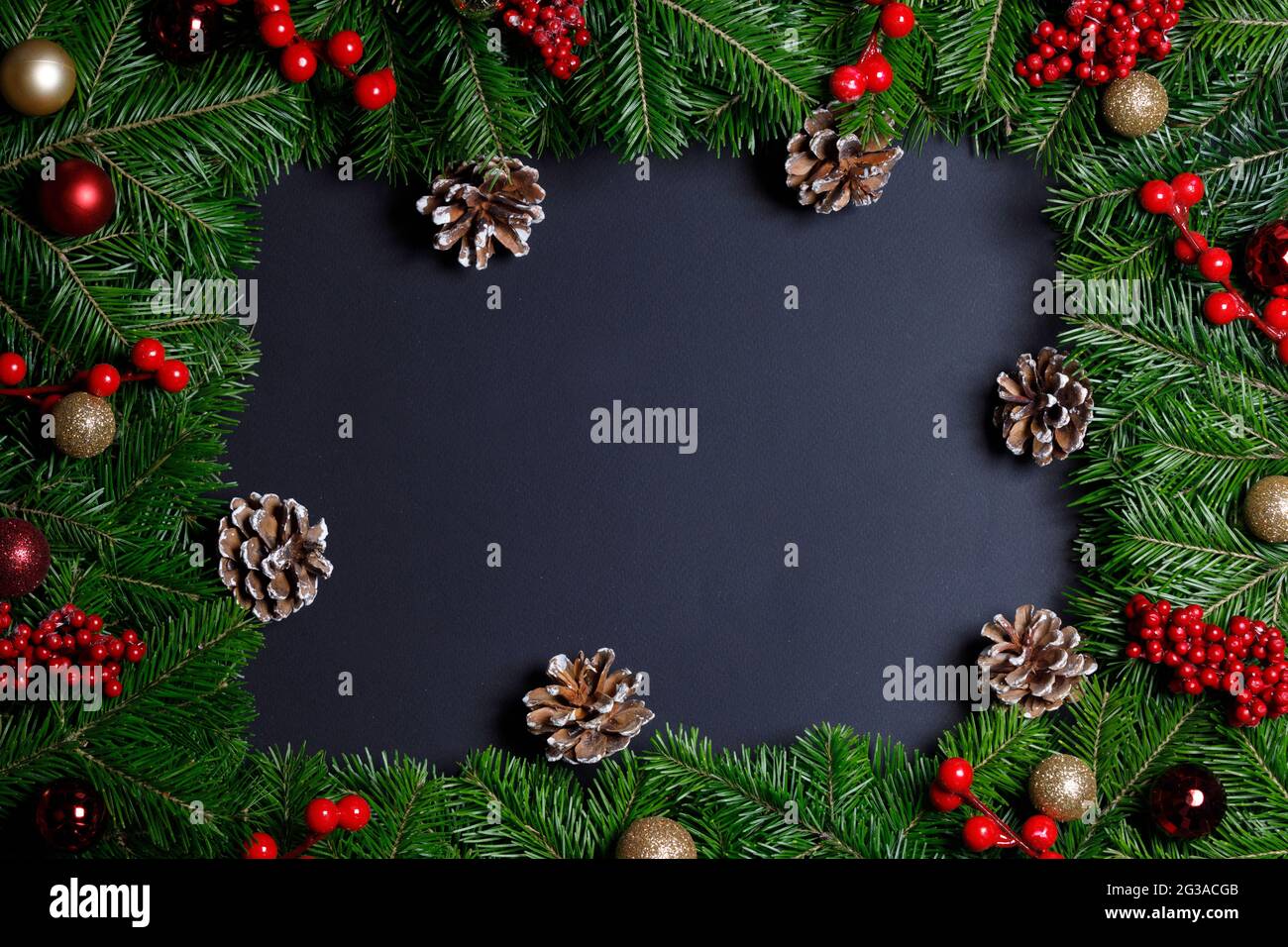 Natural fir Christmas tree border frame with decor on black, copy space ...