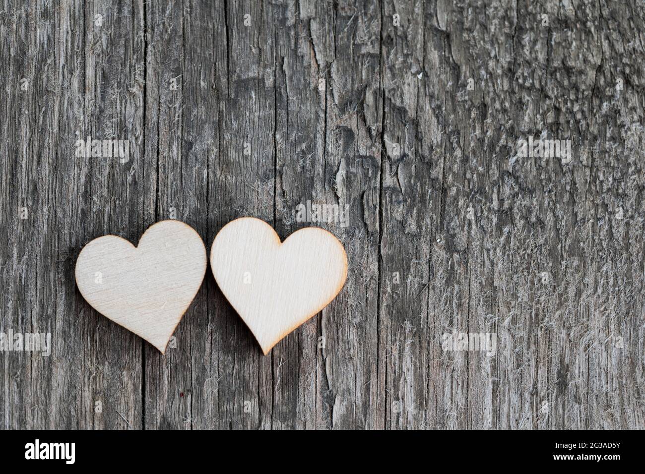 Two handmade wooden carved hearts on wood background couple relationship Valentine day concept Stock Photo
