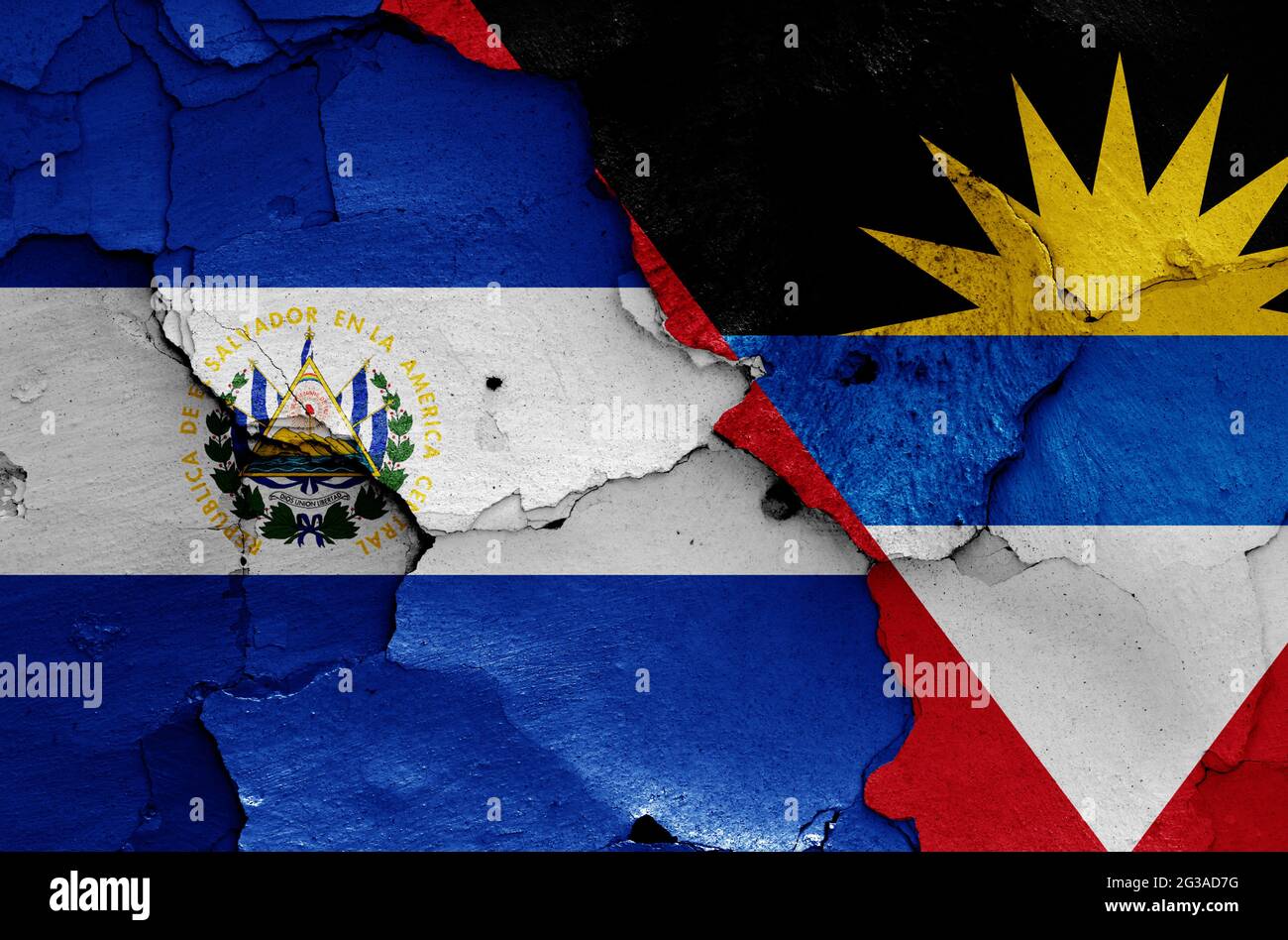 flags of El Salvador and Antigua and Barbuda painted on cracked wall Stock Photo