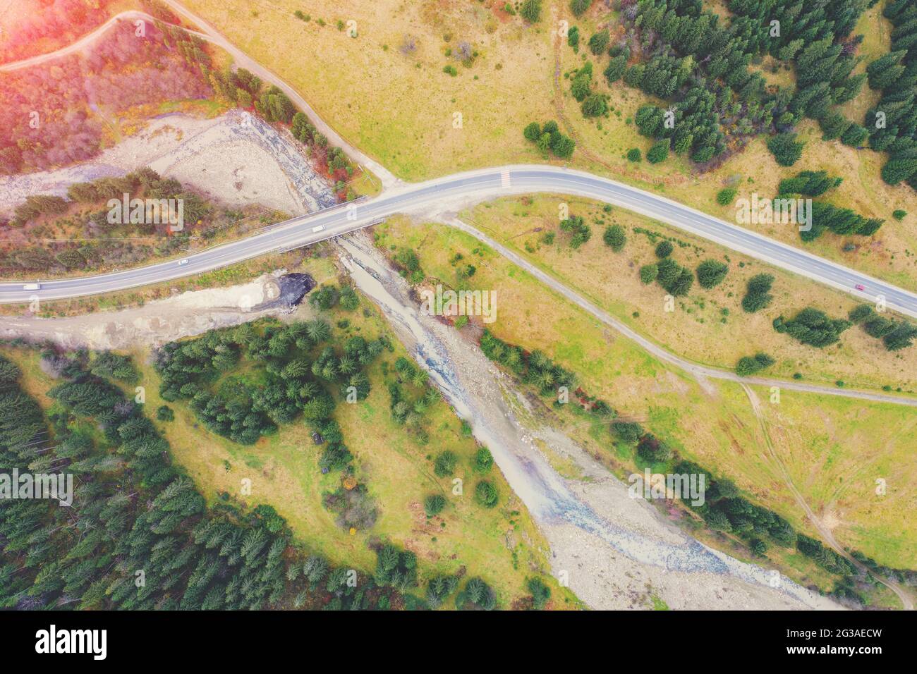 Aerial view of the mountains in autumn. The winding road along the river. Beautiful nature landscape. Bridge over the Prut River near Tatariv village, Stock Photo