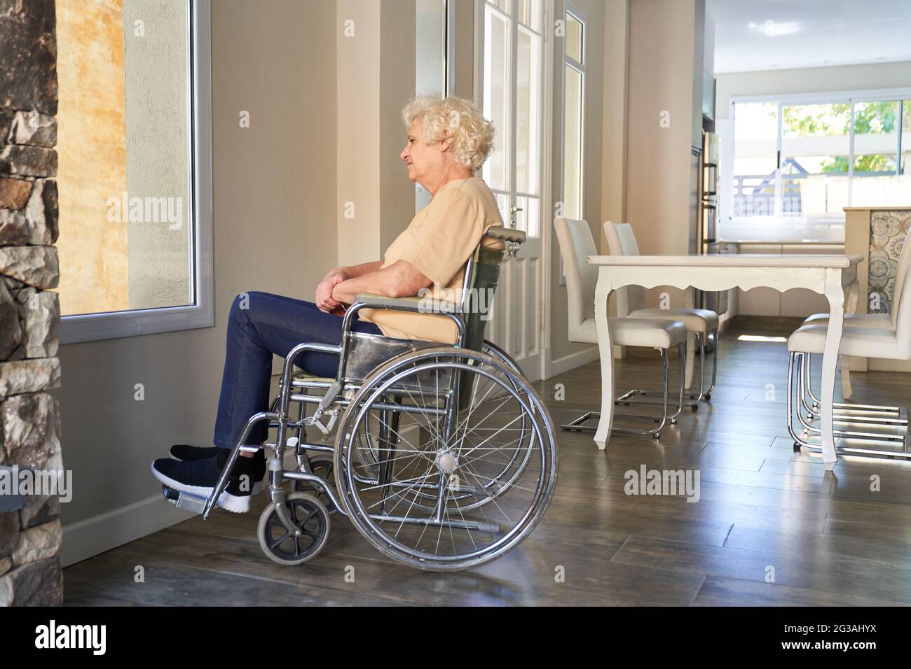 Elderly woman with paraplegia in a wheelchair after a stroke at the