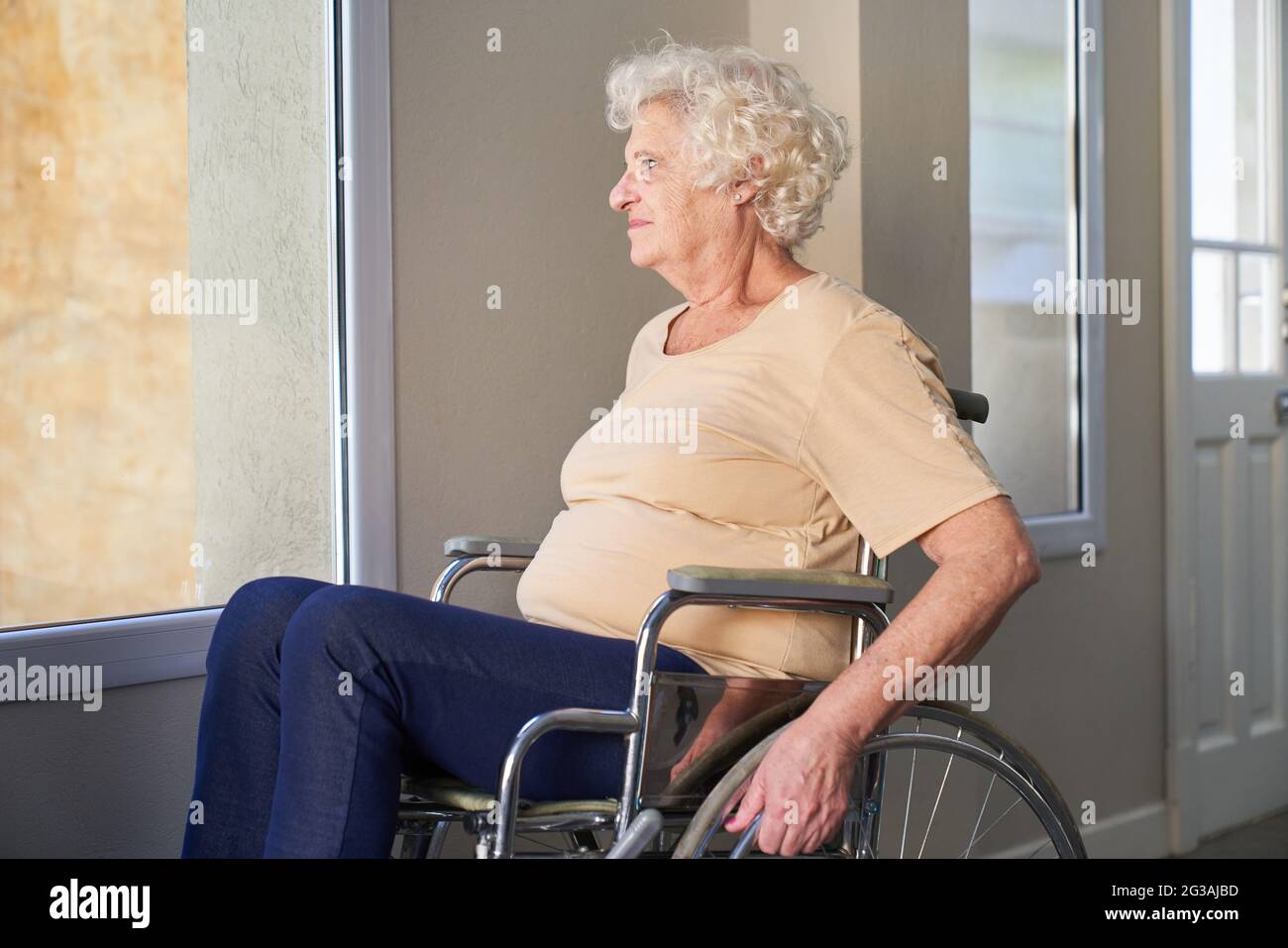 Thoughtful elderly woman after a stroke or accident in a wheelchair