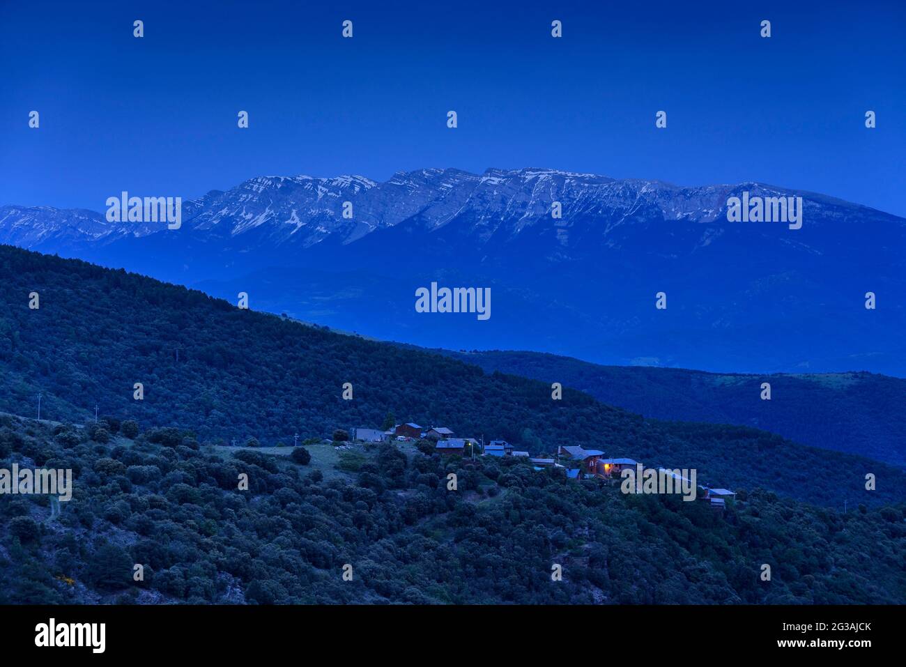 Albert village, in the Castellbò valley, with the Cadí mountain range in the background at dusk (Alt Urgell, Lleida, Catalonia, Spain) Stock Photo