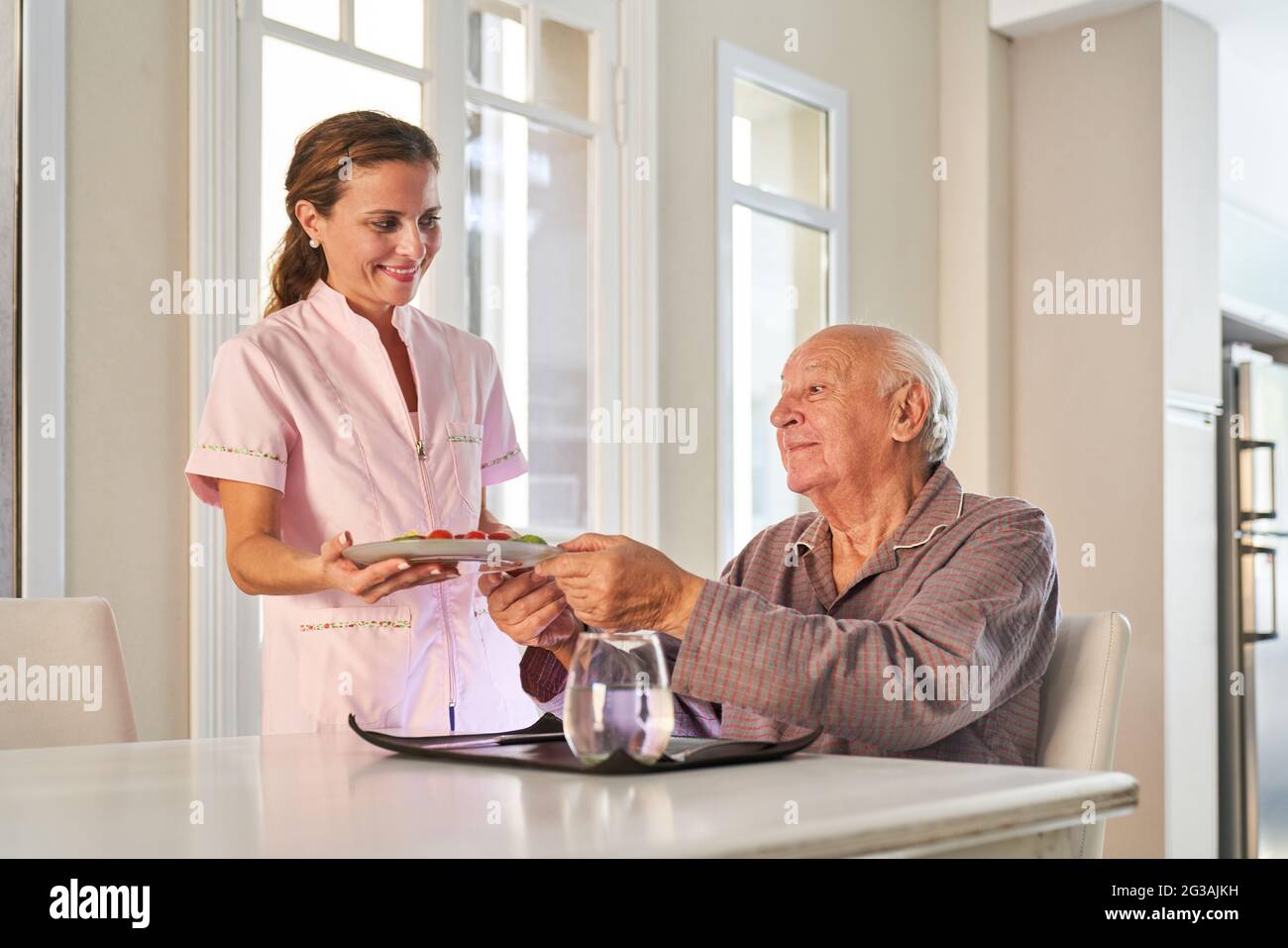 Senior has meals on wheels delivered to their homes by the delivery service Stock Photo