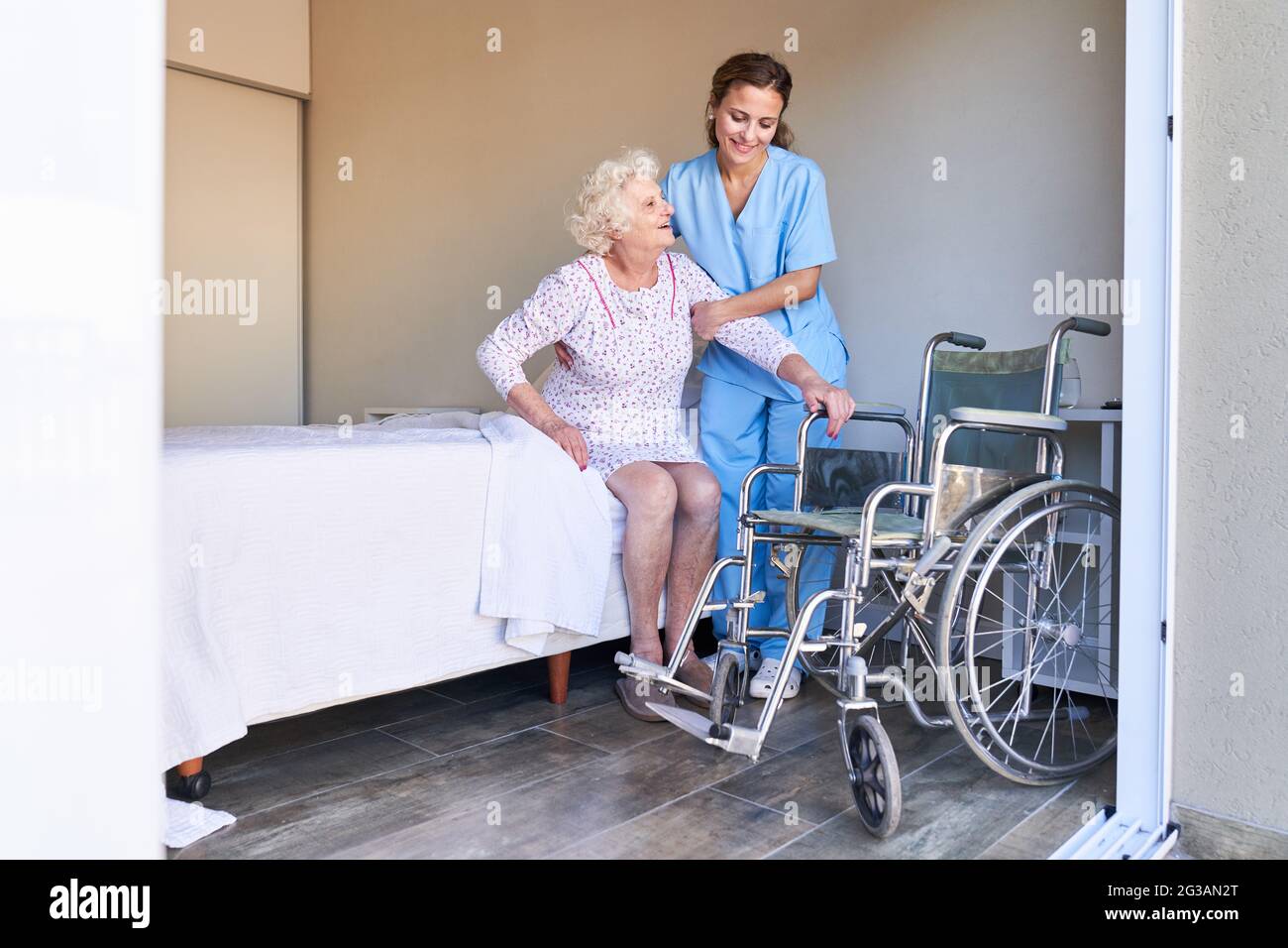 Nurse nursing stuff take care of dependend patient in wheelchair Stock  Photo - Alamy