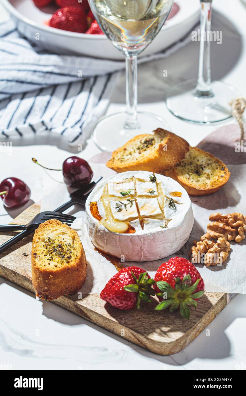 Baked cheese Camembert or Brie with thyme and maple syrup. Cheese