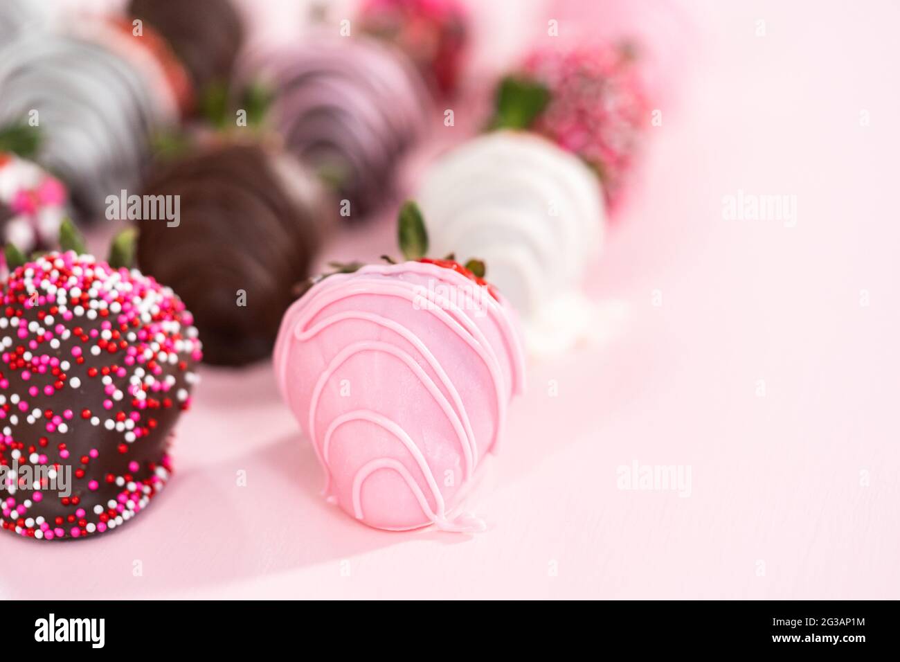 Variety of chocolate dipped strawberries on a pink background Stock ...