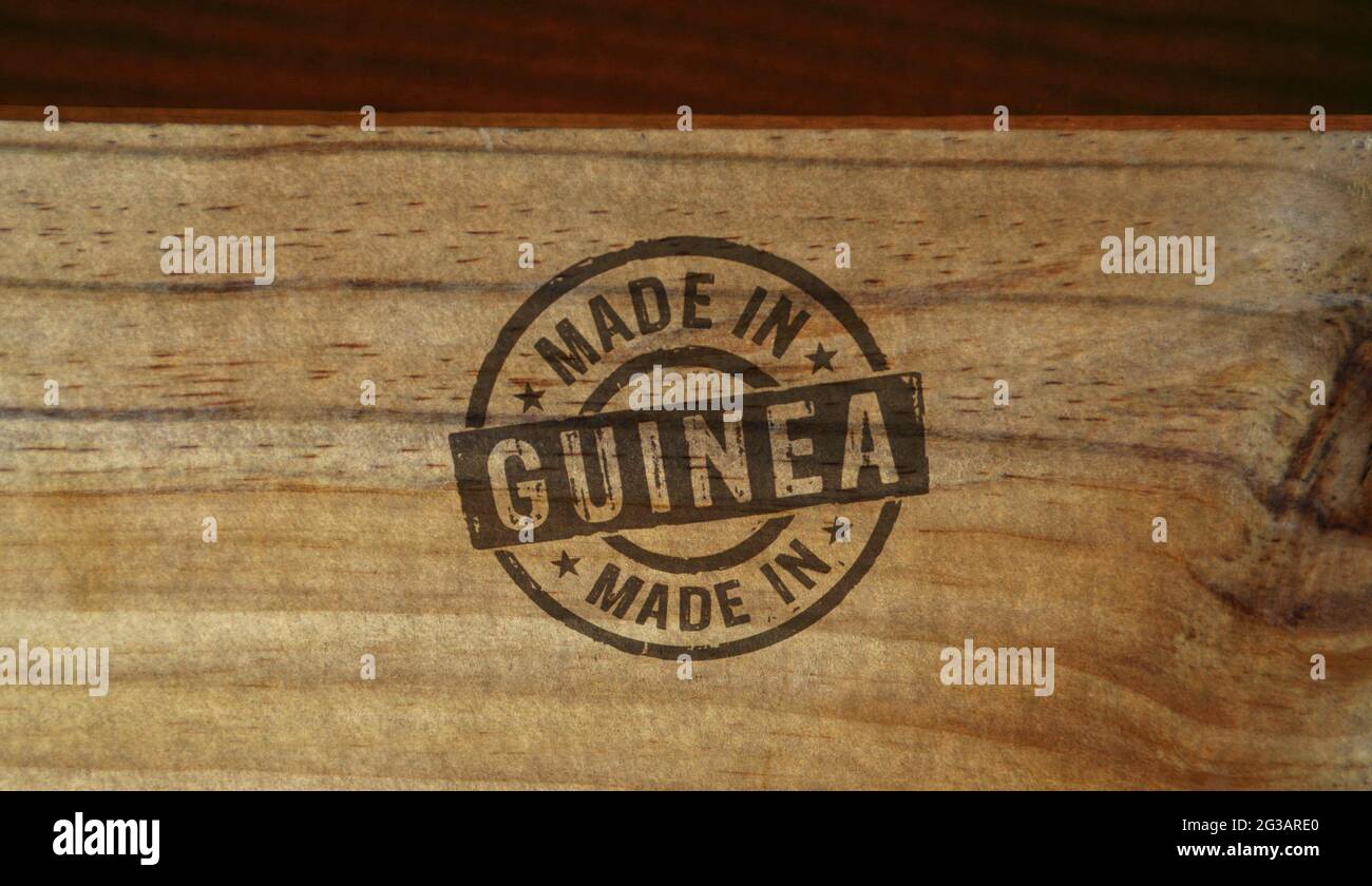 Made in Guinea stamp printed on wooden box. Factory, manufacturing and