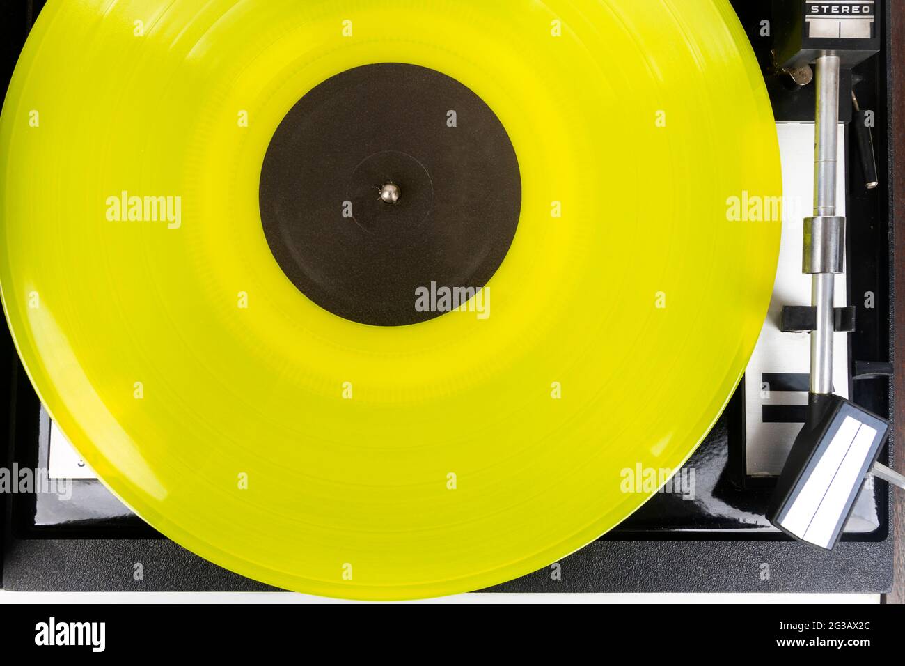 Close up of vintage turntable vinyl record player with yellow vinyl ...