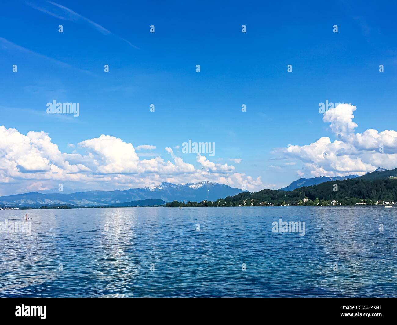 Idyllic Swiss landscape, view of lake Zurich in Richterswil, Switzerland, mountains, blue water of Zurichsee, sky as summer nature and travel Stock Photo