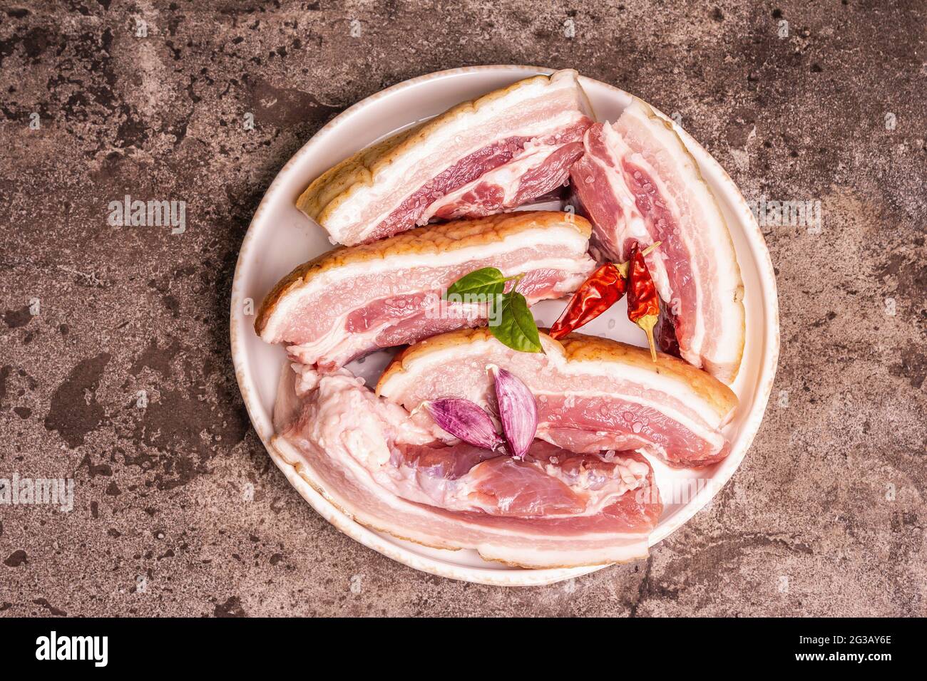 Raw pork belly with rind, peritoneum meat. Spices and herbs