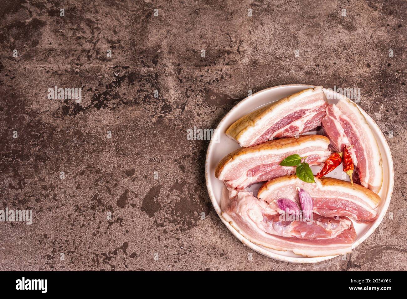 Raw pork belly with rind, peritoneum meat. Spices and herbs