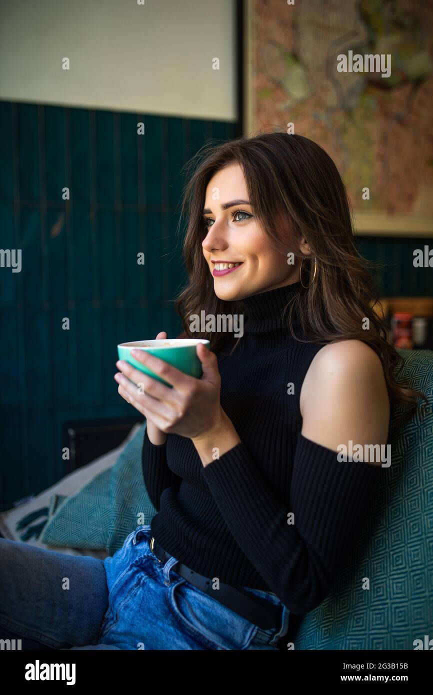 Portrait of young woman smiling in coffee shop cafe Stock Photo - Alamy