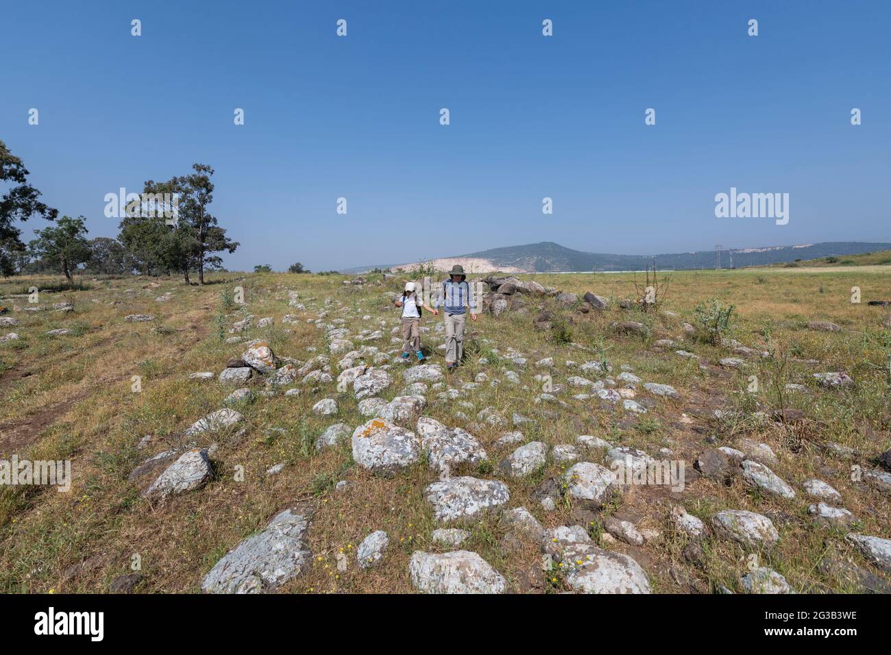 Father-son hiking on the Roman road between Acre and Tiberias, it was likely the path used by Jesus on his journey from Nazareth to the Sea of Galilee Stock Photo