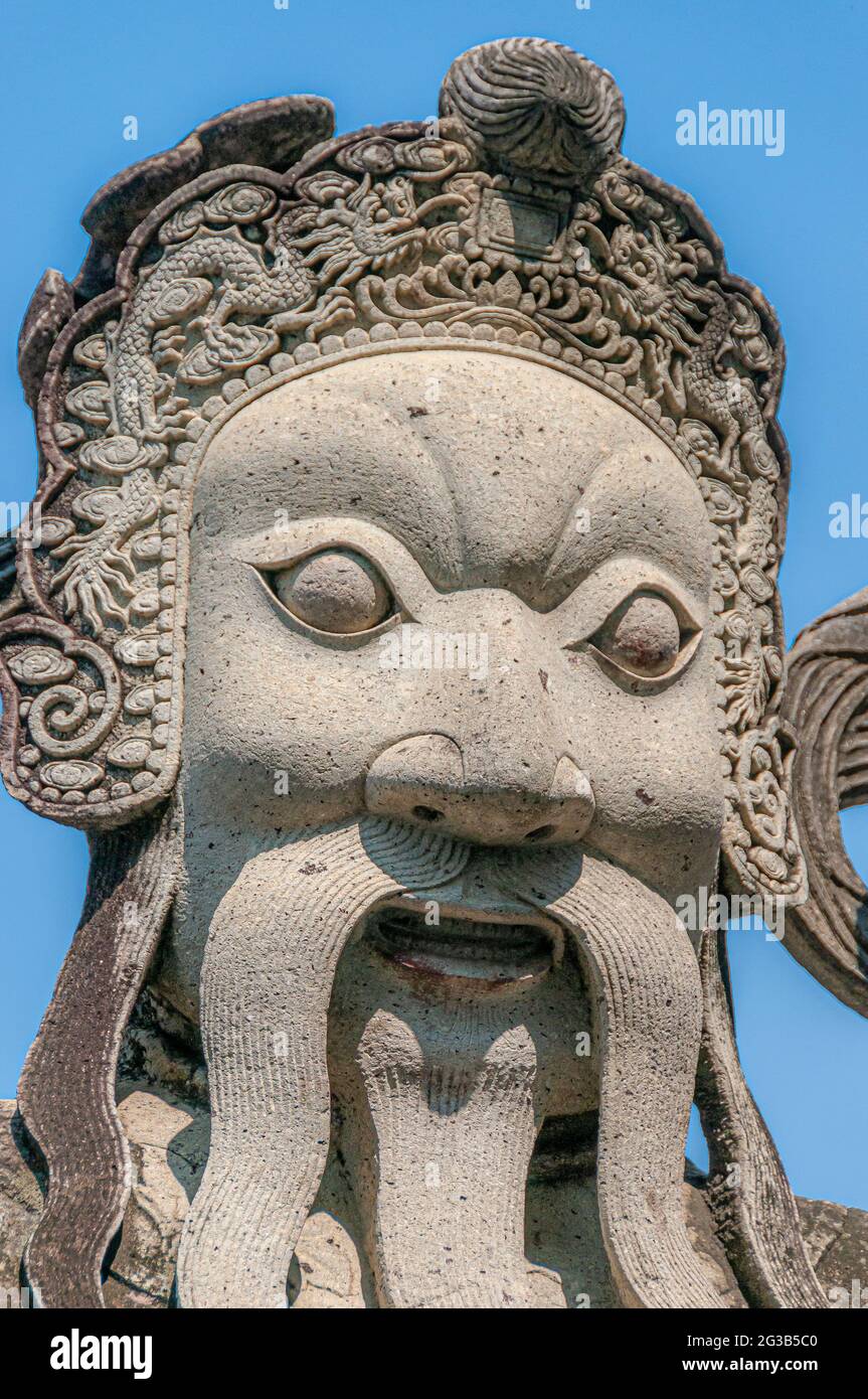 A Chinese guardian bearded man statue in the Wat Pho Wat Po temple complex in Bangkok in Thailand in South East Asia. Stock Photo