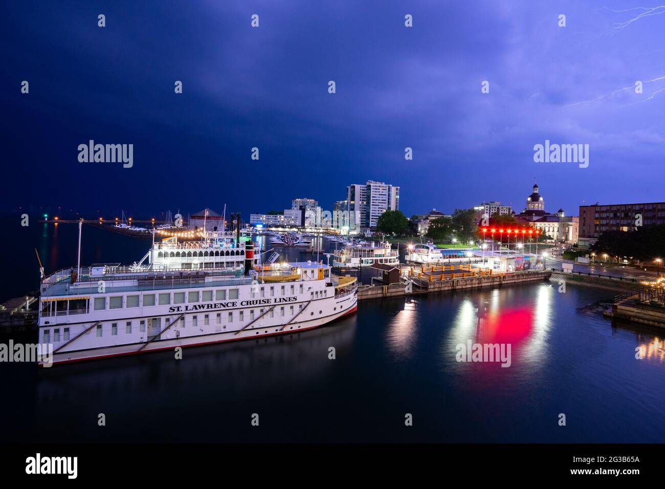 Electric storm over the Crawford Wharf in Kingston, Ontario, with the Canadian Empress on the foreground, the Island Queen III behind it and lightning Stock Photo