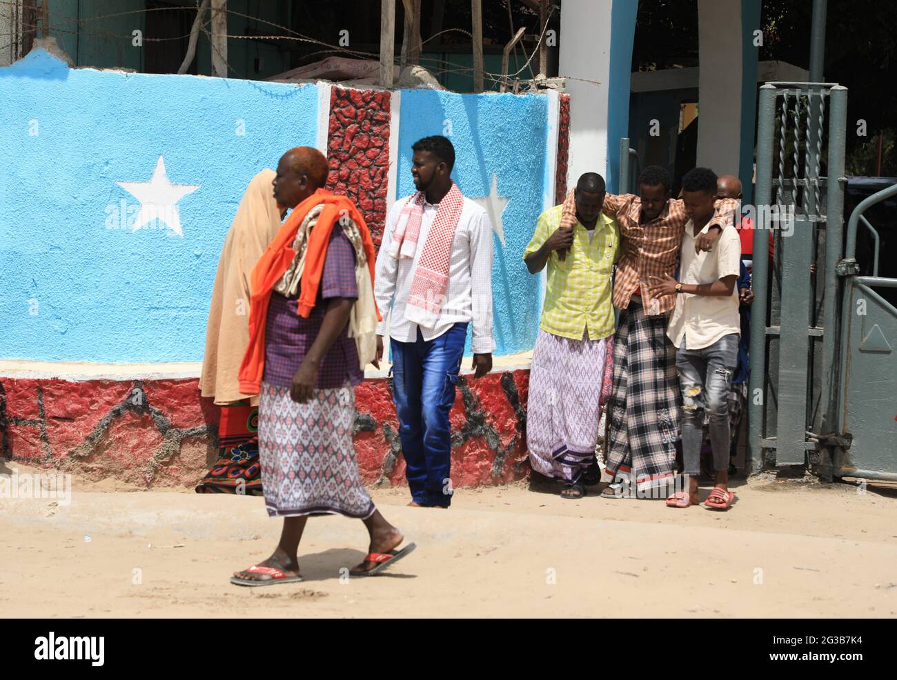 Mogadishu, Somalia. 15th June, 2021. A wounded person walks with assistance at the entrance of