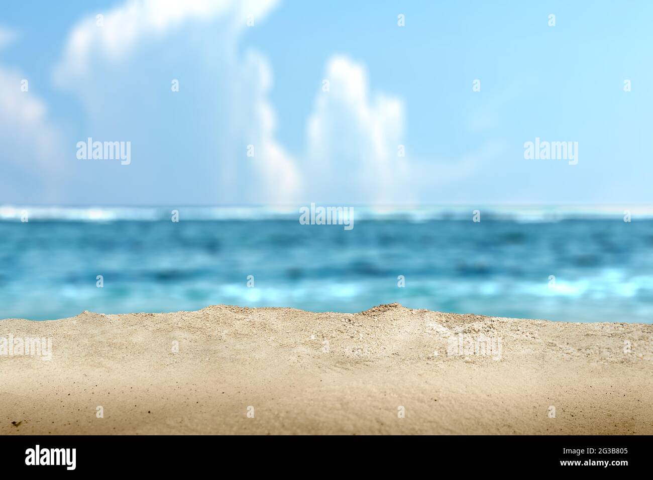Sandy beach with the blue ocean and blue sky background Stock Photo - Alamy