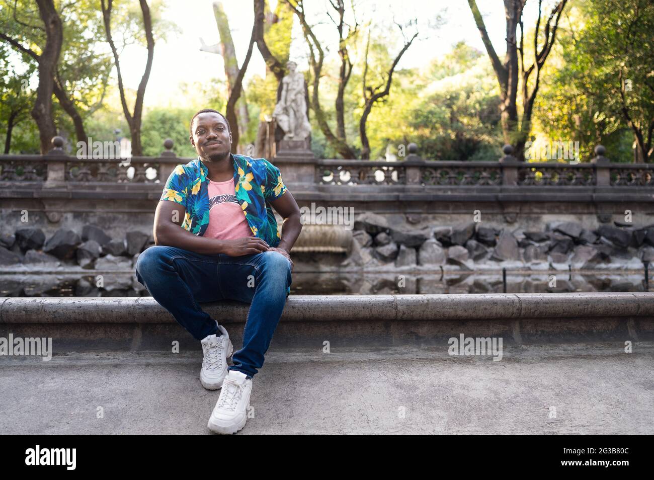 Young stylish handsome ?exican male in a park Stock Photo