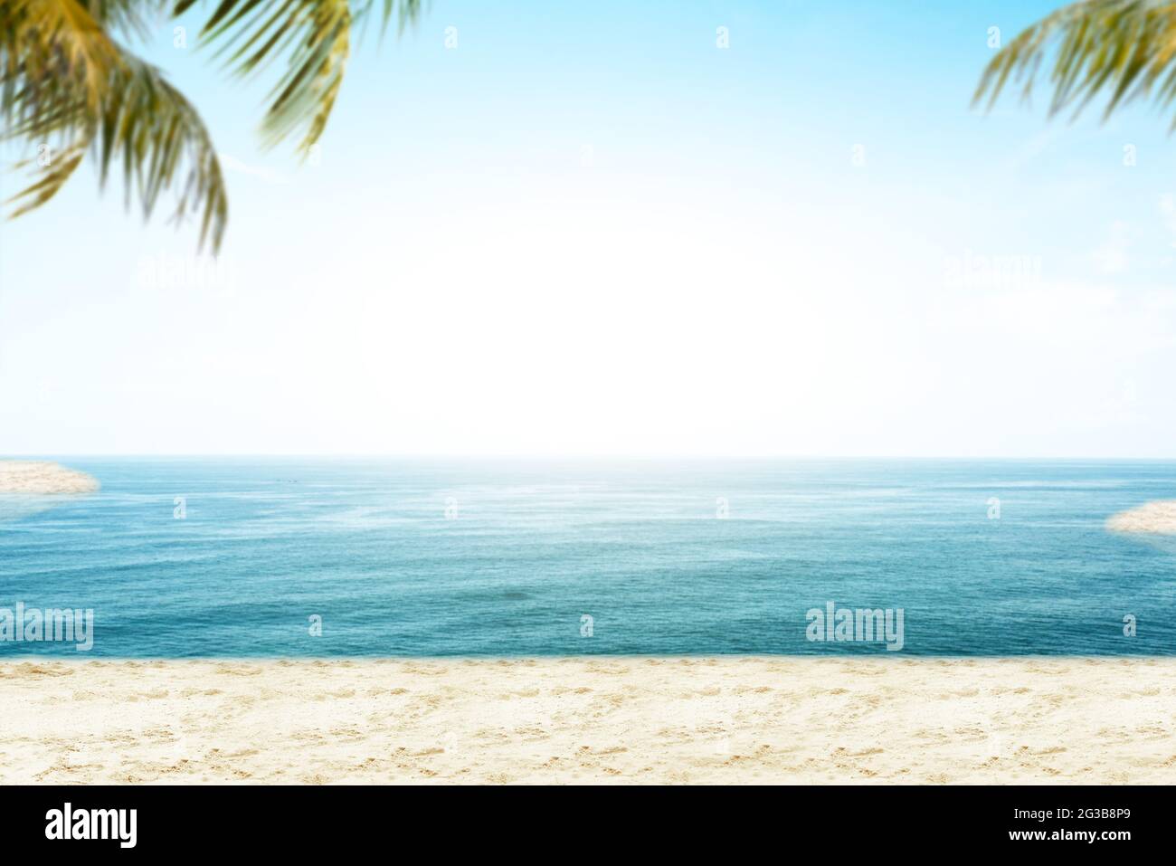 Sandy beach with the blue ocean and blue sky background Stock Photo - Alamy