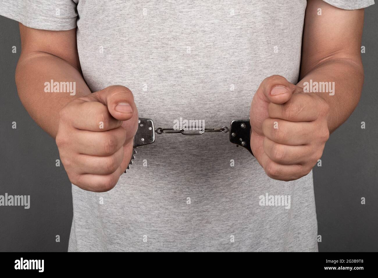 a man in handcuffs arrested was detained by law enforcement agencies. Stock Photo