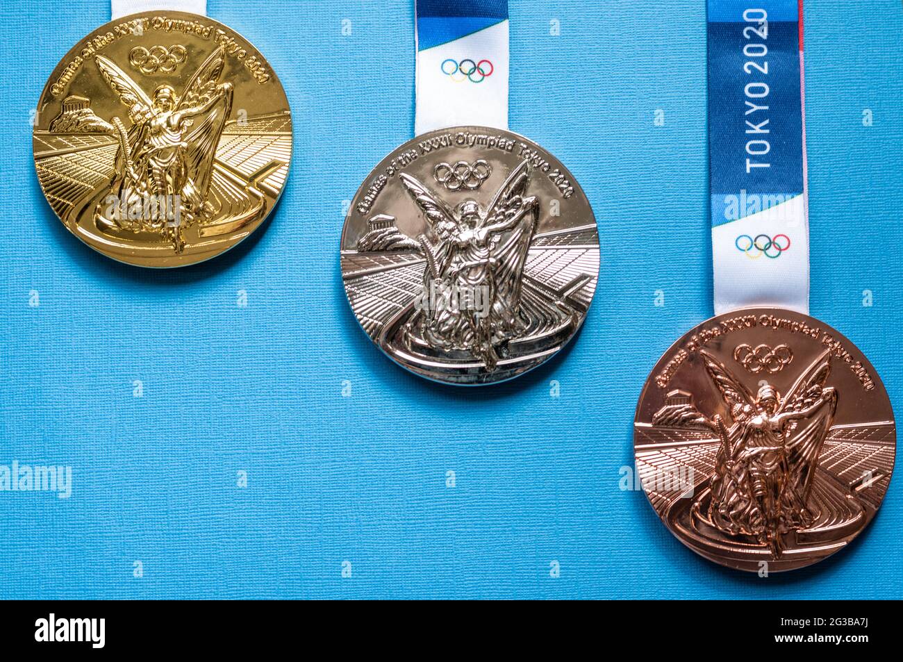 April 25, 2021 Tokyo, Japan. Gold, silver and bronze medals of the XXXII  Summer Olympic Games in Tokyo on a blue background Stock Photo - Alamy