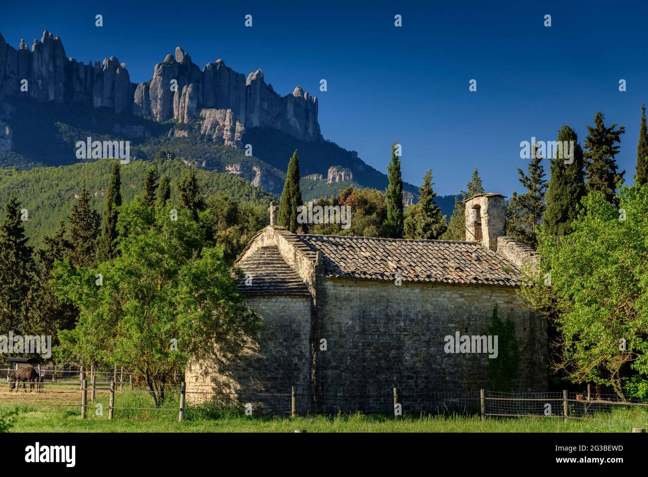 Sant Jaume de Castellbell Hermitage in spring. In the background, the Montserrat mountain  (Bages, Barcelona, Catalonia, Spain) Stock Photo