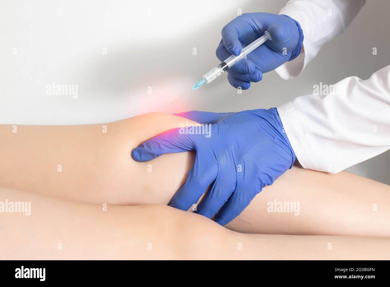 The doctor injects an ozone-oxygen mixture into the patient's knee joint to relieve muscle spasm and inflammation. Ozone therapy, copy space for text, Stock Photo