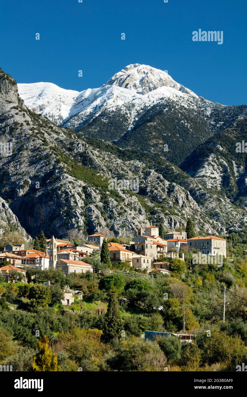 Chora village near Exohori in the Mani peninsula of Greece with the snow-capped Taygetos mountains beyond Stock Photo