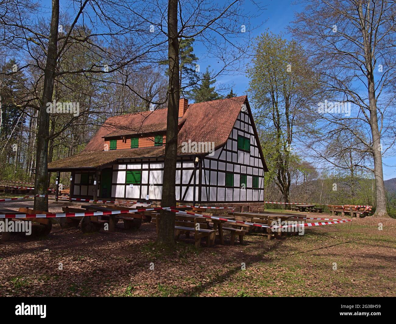 Closed restaurant in historic half-timbered building surrounded by trees in spring season near Annweiler am Trifels, Germany in Palatinate Forest. Stock Photo