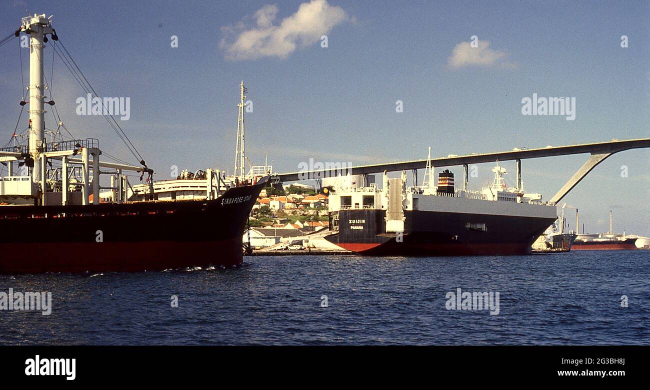 Merchant Ships (Car Carrier, Bulk Cargo) passing under the bridge at Christianstad, Curacao. Stock Photo