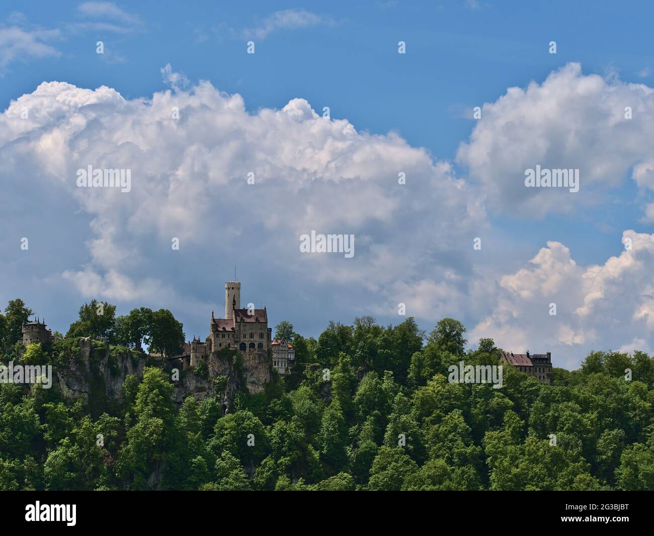 Stunning view of famous Lichtenstein castle located on rock on the edge ('Albtrauf') of Swabian Alb, Baden-Württemberg, Germany with green forest. Stock Photo