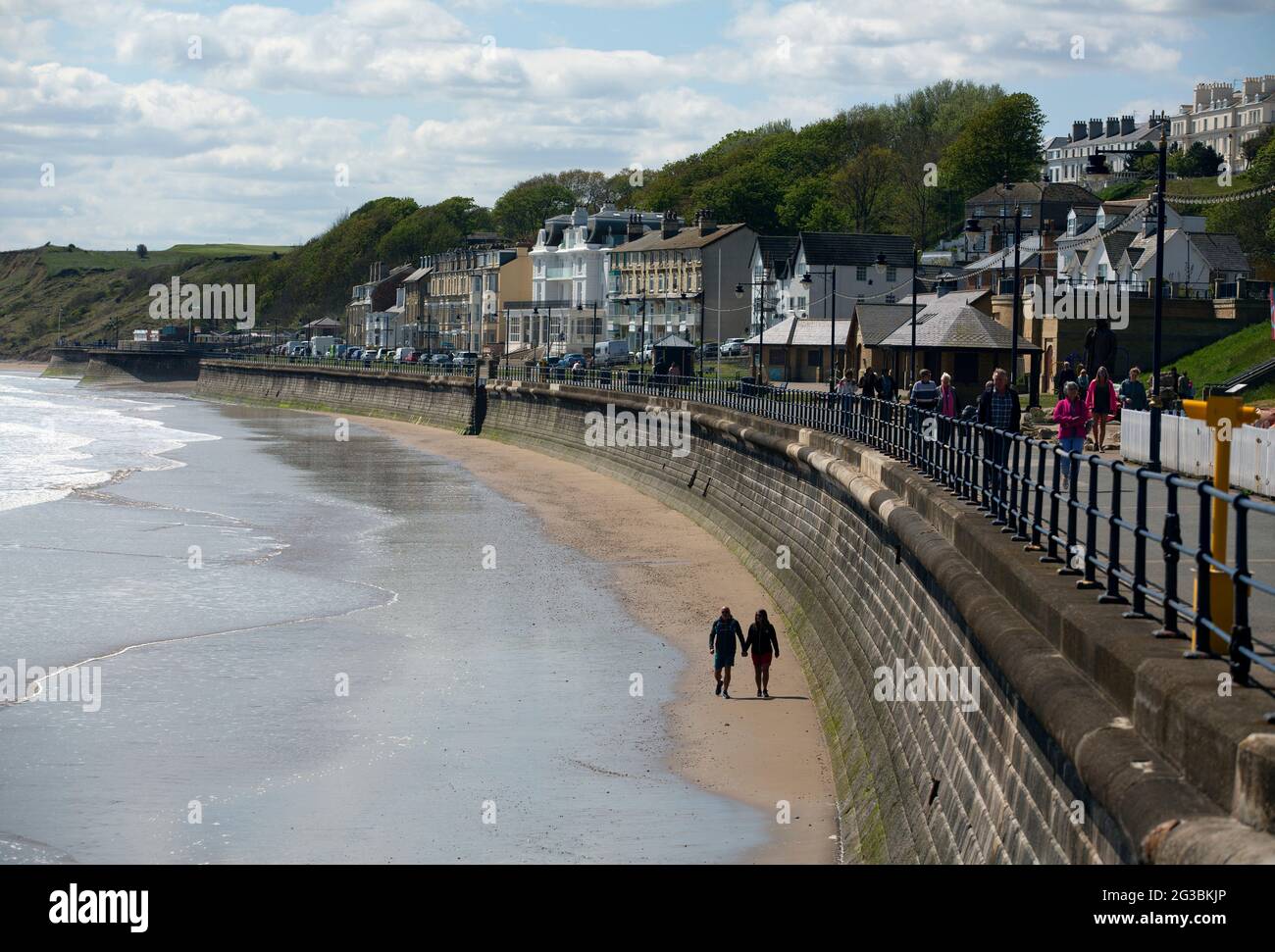 A couple (Mark Allitt,58, retired & Sarah Mason,51, a NHS medical receptionist & key worker) walk hand in hand in Filey in north Yorkshire. Filey is a Stock Photo