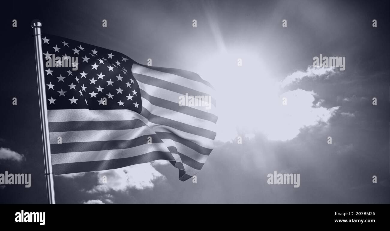 Monochrome composition of american flag on pole billowing against sunny, cloudy sky Stock Photo