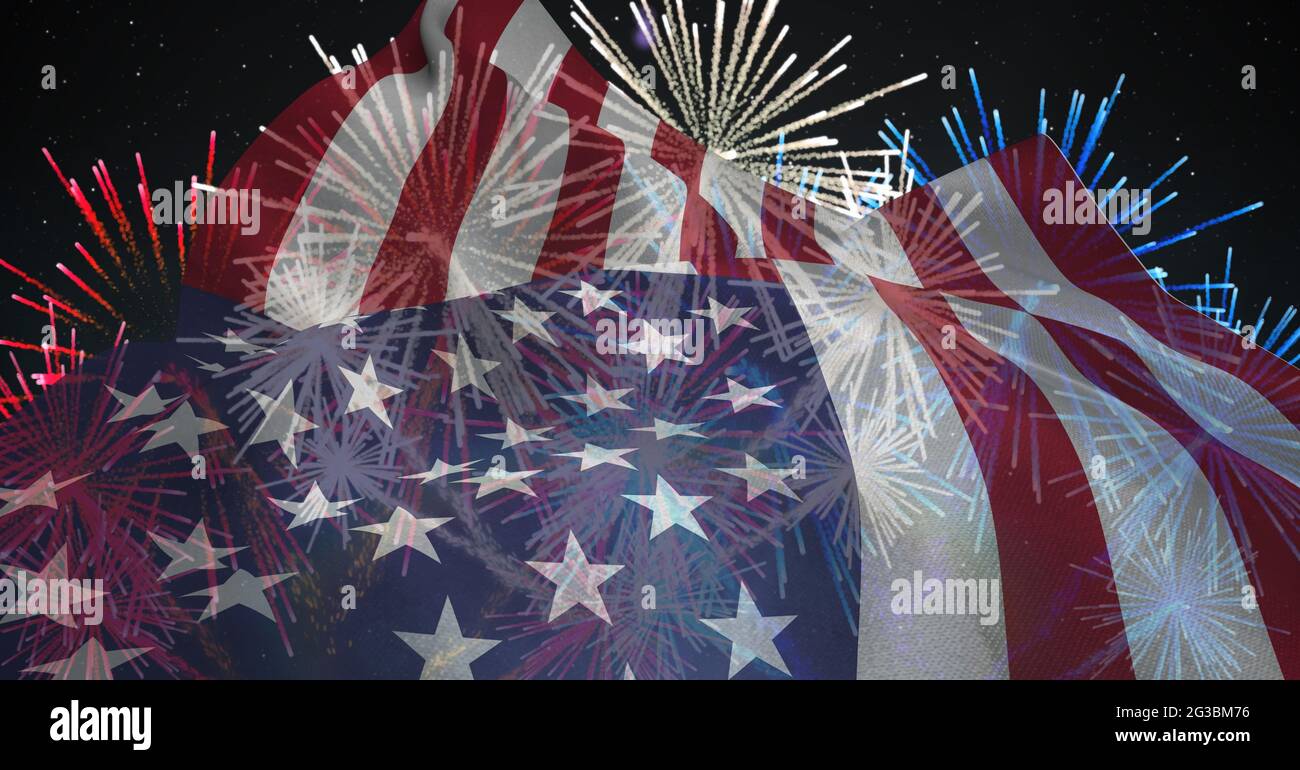 Composition of american flag billowing over red, white and blue fireworks in night sky Stock Photo