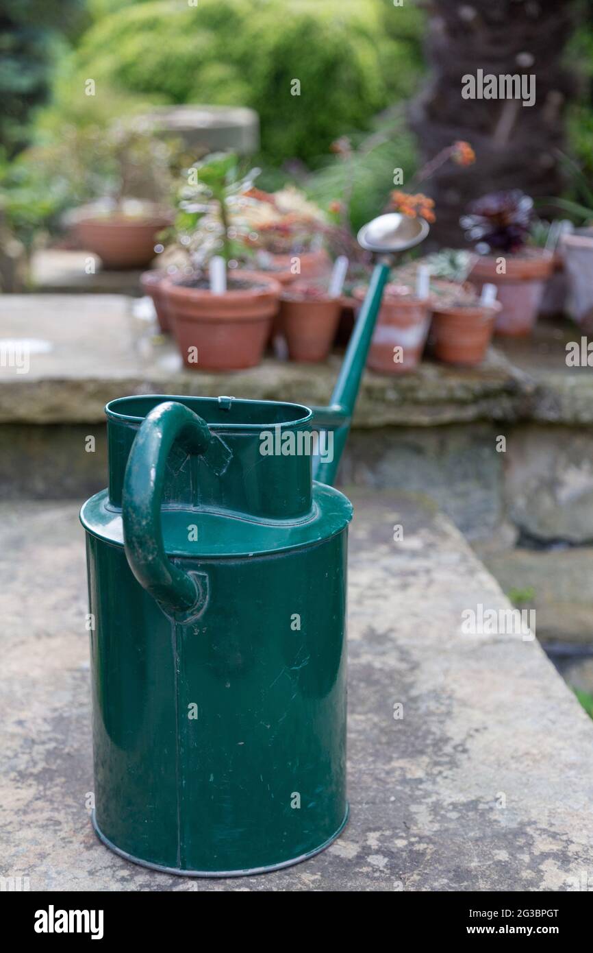 A watering can and plant pots at York Gate Garden, Leeds Stock Photo Alamy