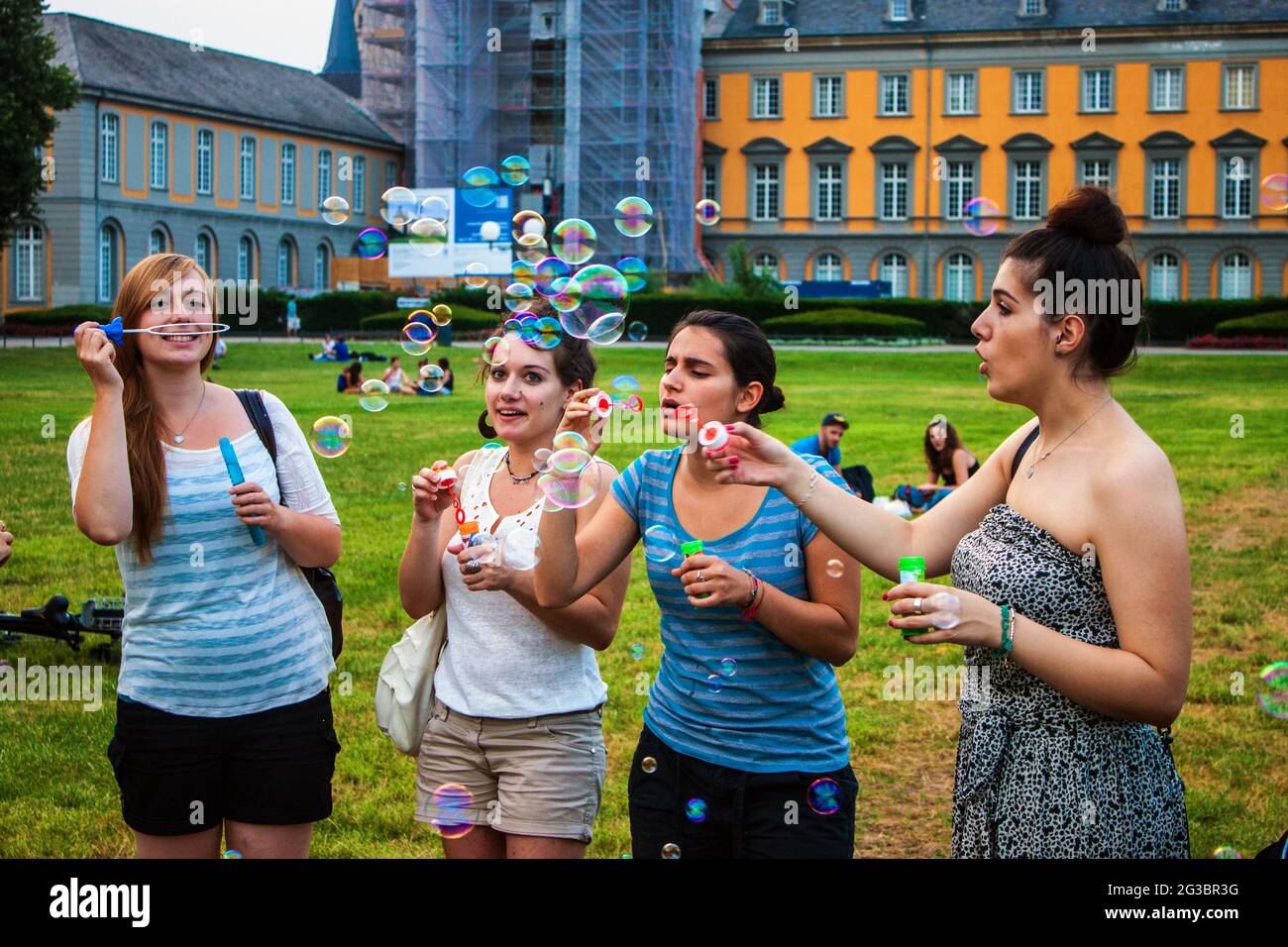 BONN, GERMANY - JULY 22: Students of University in Bonn blow bubbles on July 22, 2013 in Bonn, Germany. University Bonn hat 31,000 students. Stock Photo