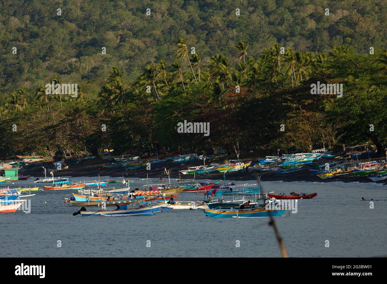 Batu Putih, Indonesia - September 30, 2019: Dozens of colorful fishing boats moored near the beach, Tangkoko Nature Park, Sulawesi, Indonesia Stock Photo