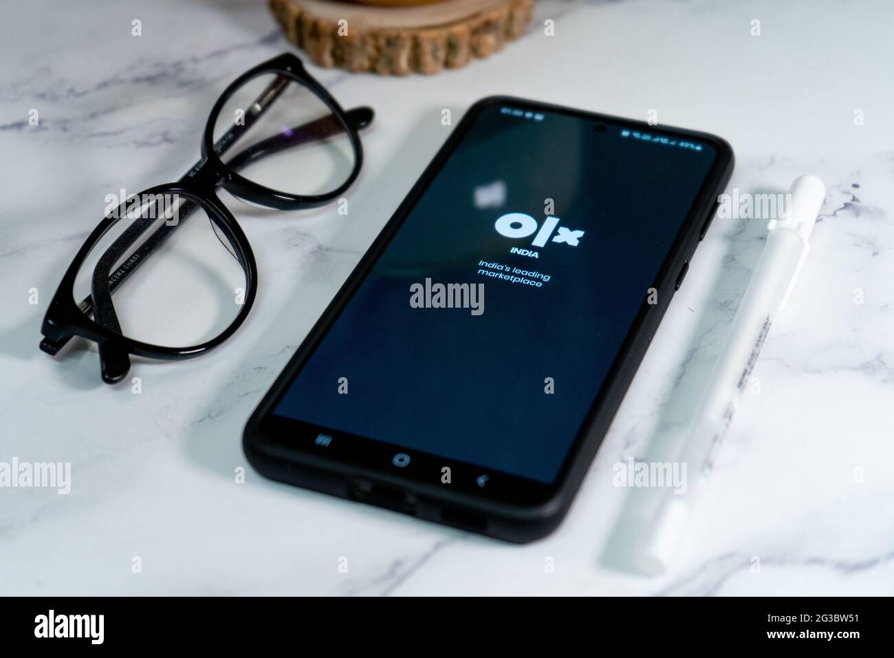 flatlay shot of mobile phone showing the logo of olx india's largest second  hand reseller marketplace similar to ebay and craigslist in India asia  Stock Photo - Alamy