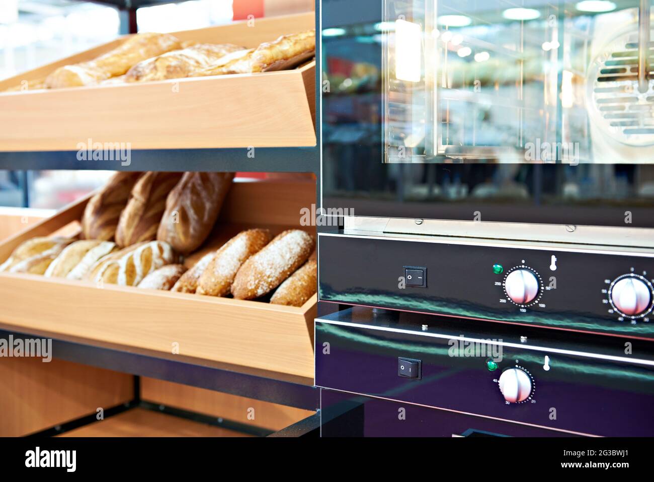 Oven and loaves of bread on a shelf in a bakery Stock Photo Alamy