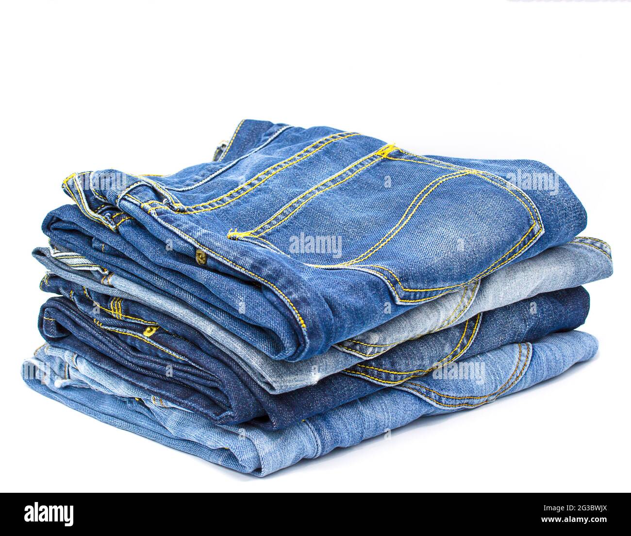 Jeans stacked on white background with copy space Stock Photo - Alamy
