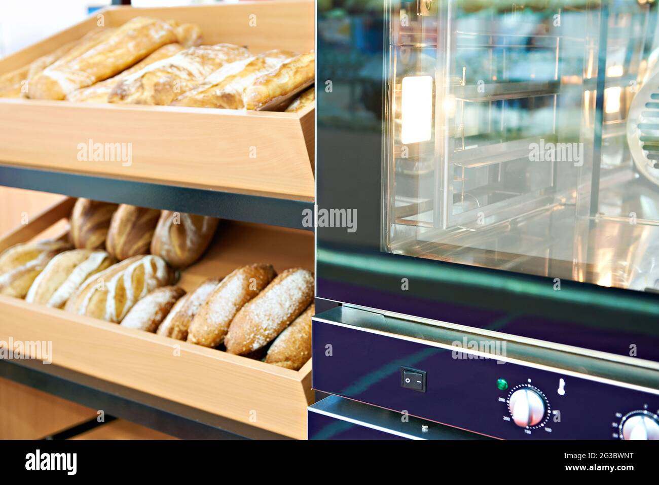 Oven and loaves of bread on a shelf in a bakery Stock Photo Alamy
