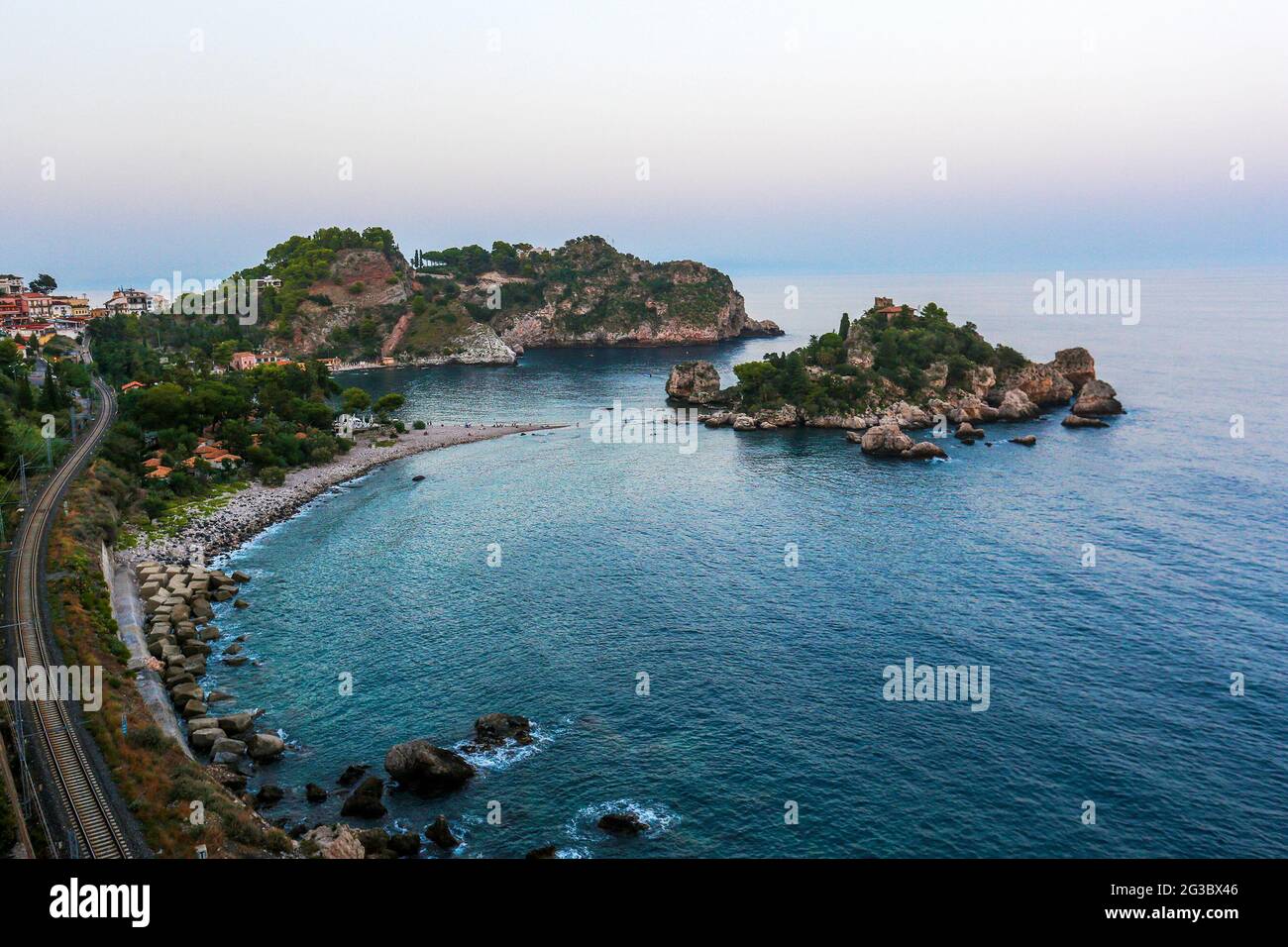 Wonderful Place near Taormina  - beautiful island   'Isola Bela'  and blue water of Mediterranean Sea.  Unrecognizable persons on the beach swimming , Stock Photo