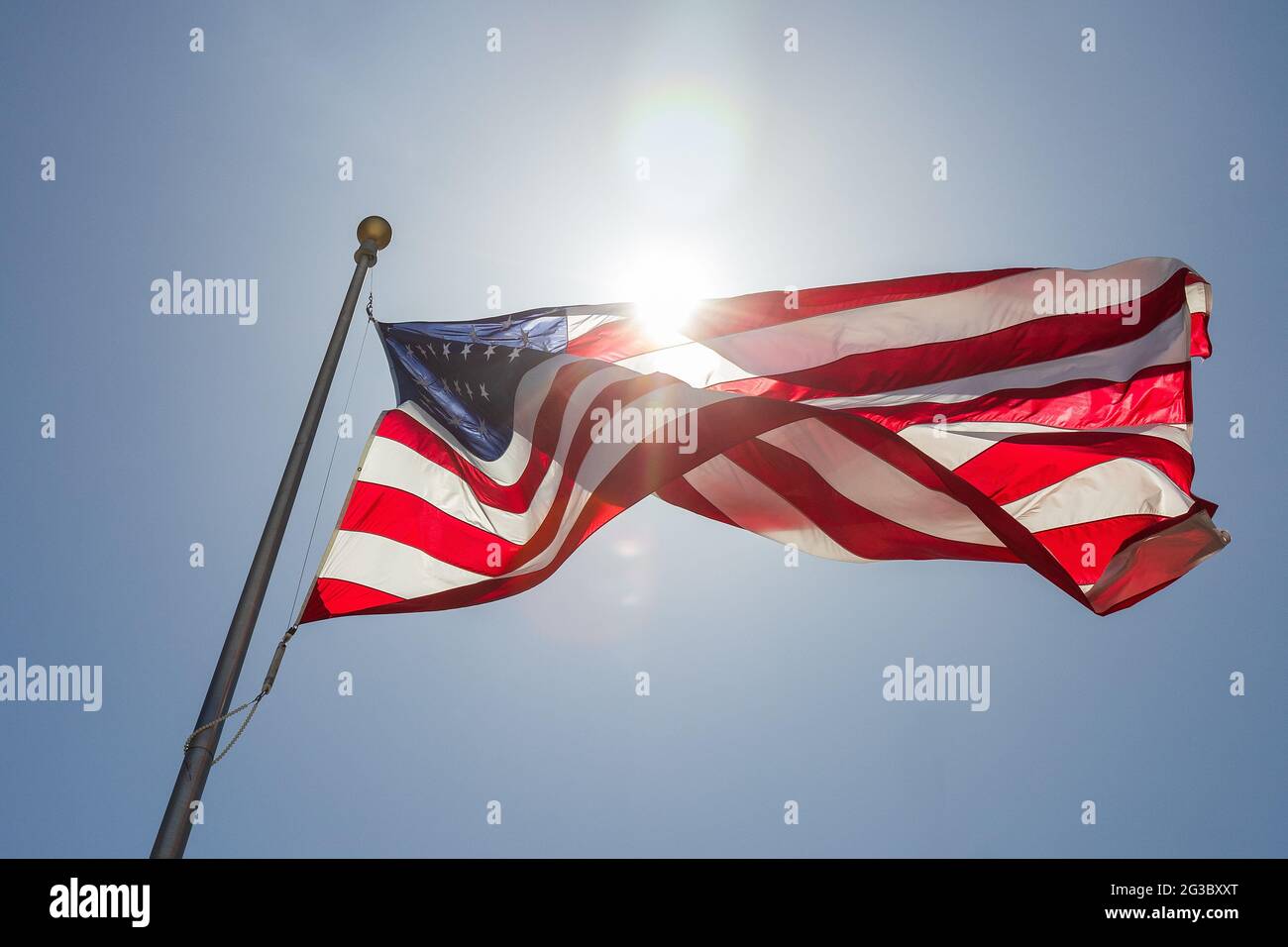 United States Flag flies on sunny day with blue skies.. Stock Photo